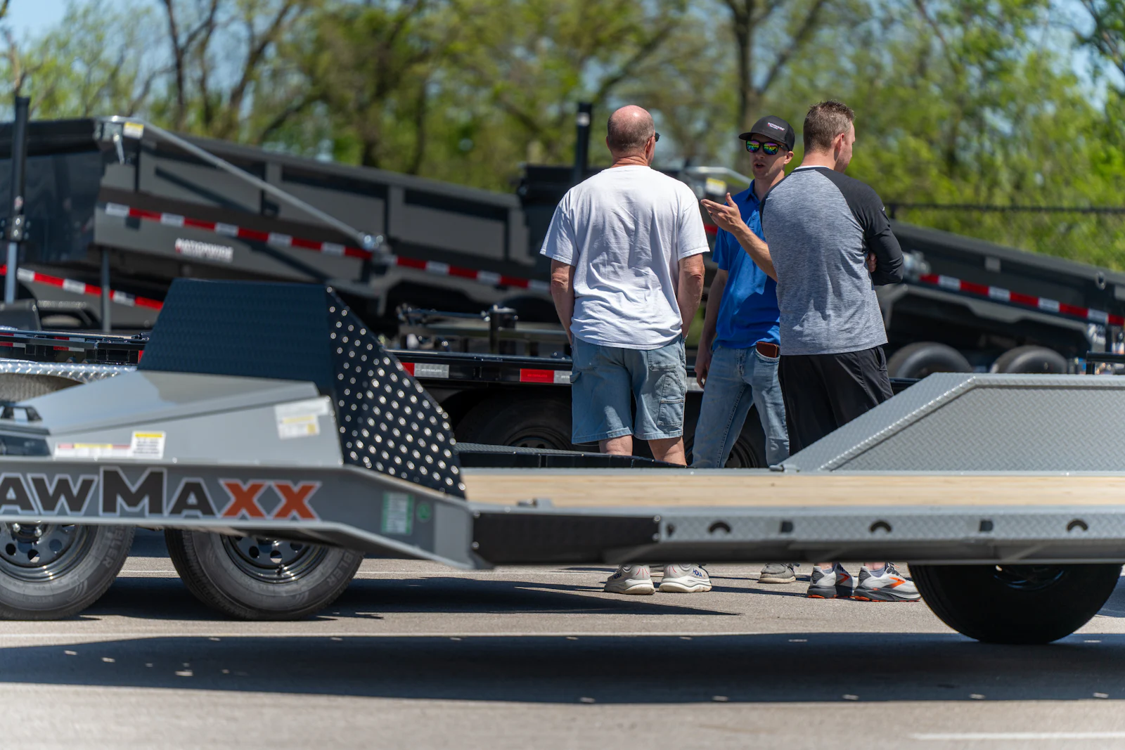Sales advisor walking customers through dump trailers on the Kansas City lot