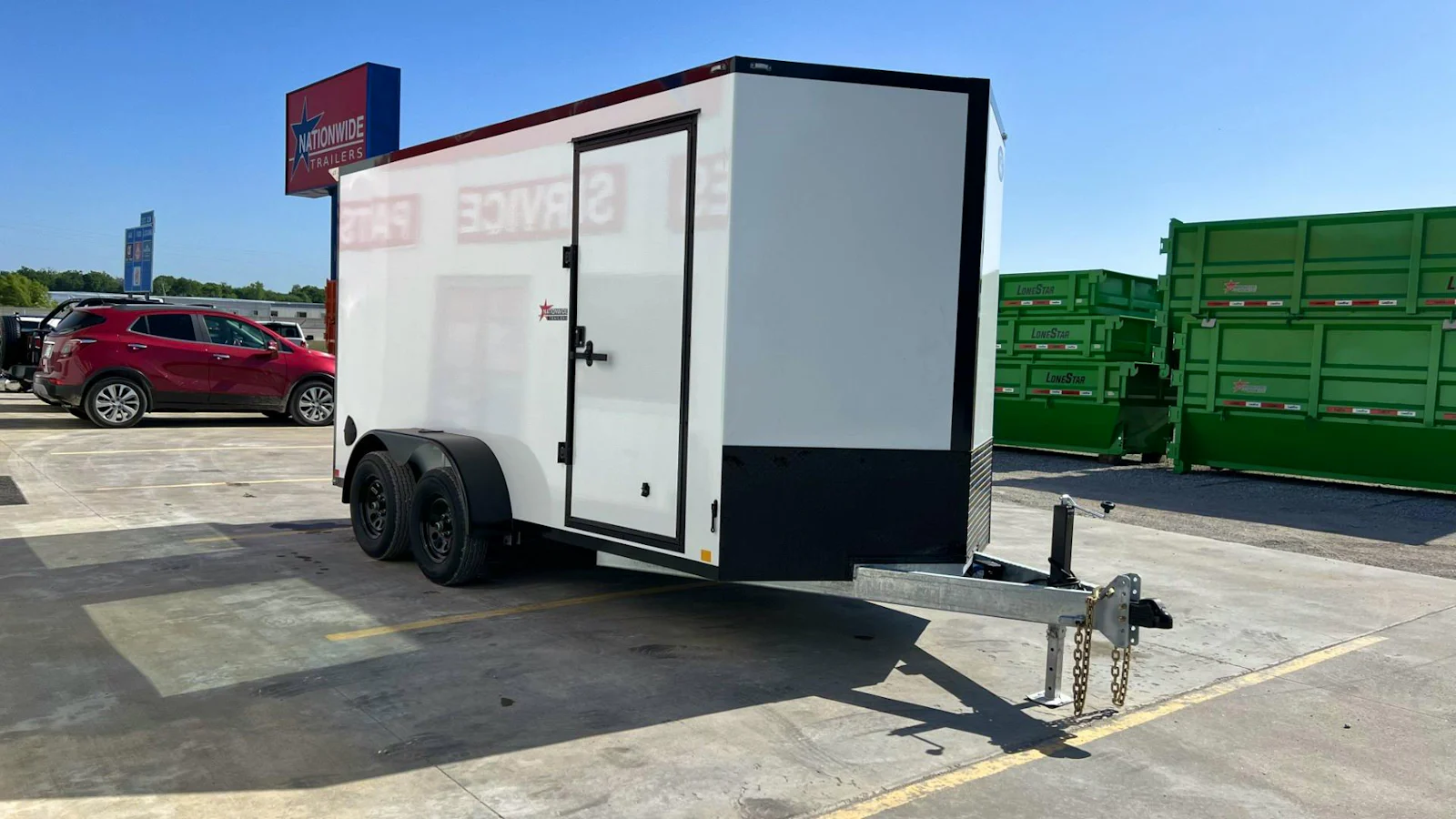White enclosed cargo trailer with blackout trim, front three-quarter view