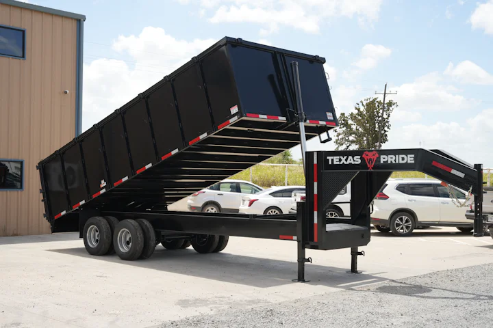 Texas Pride 20-foot by 102-inch gooseneck dump trailer with 48-inch sides and dual 12K axles, raised bed, front passenger-side view