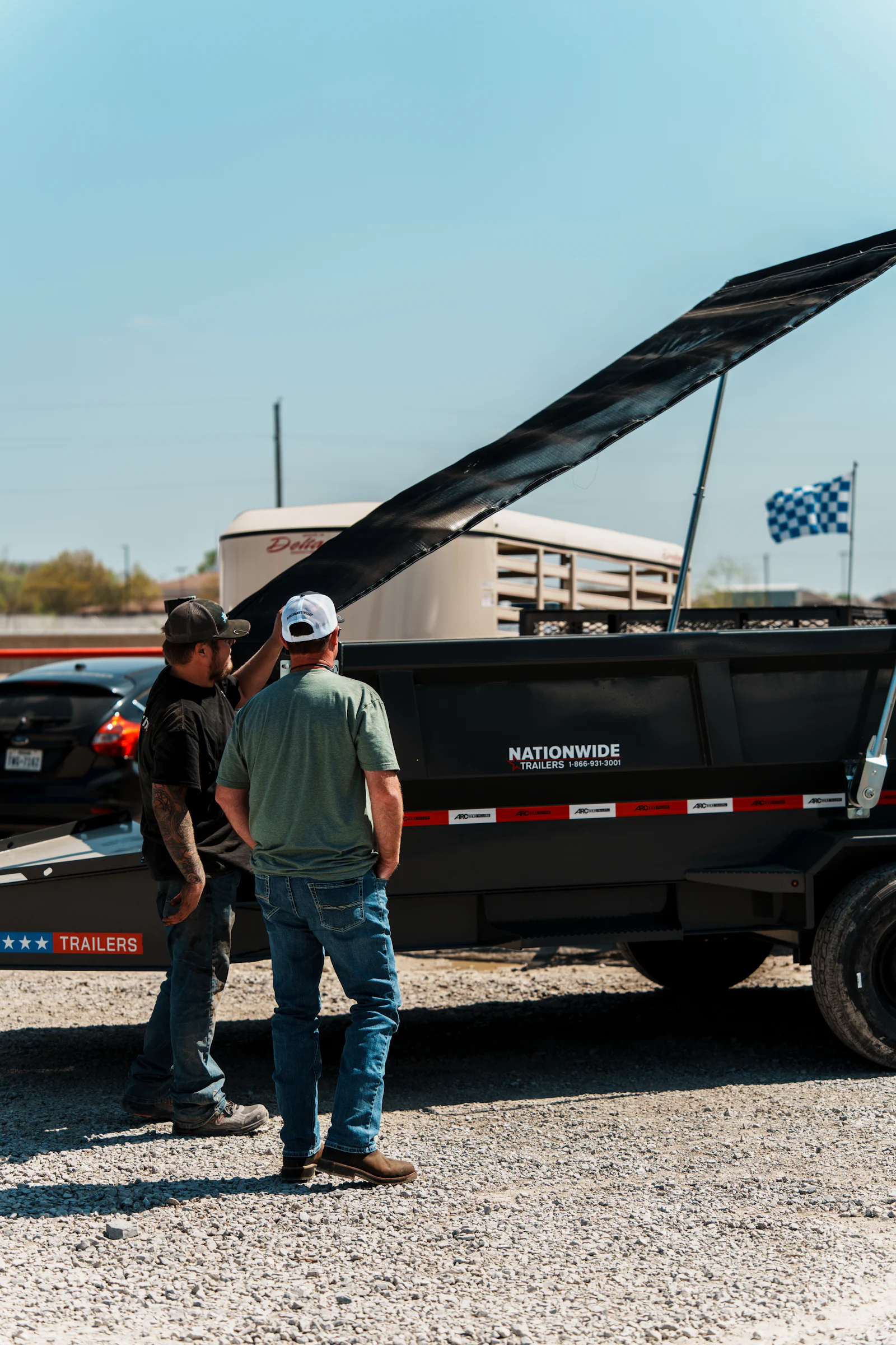 Showing a customer a dump trailer at Nationwide Trailers Van Alstyne