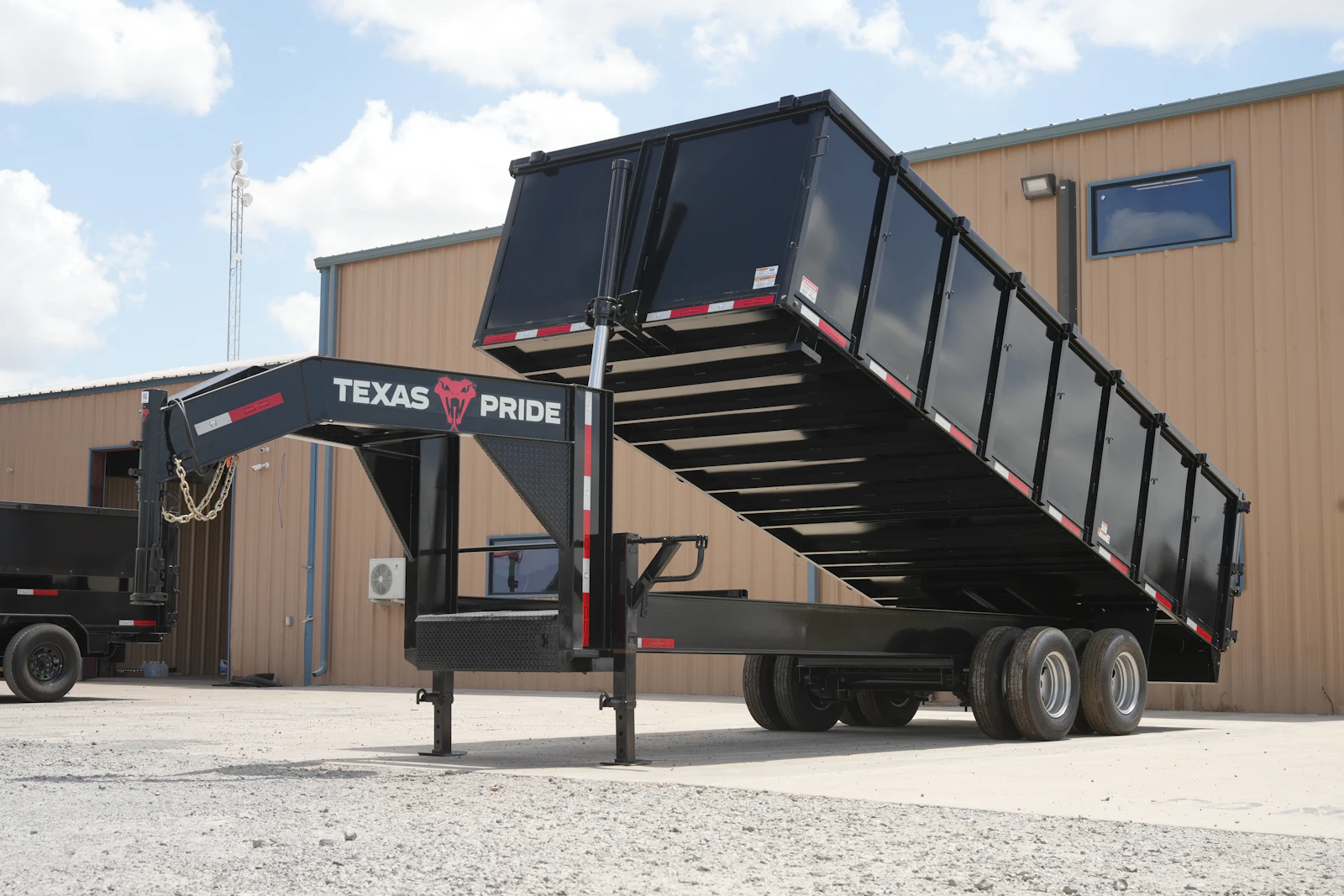 Texas Pride 20-foot by 102-inch gooseneck dump trailer with 48-inch sides and dual 12K axles, raised bed, front driver-side view