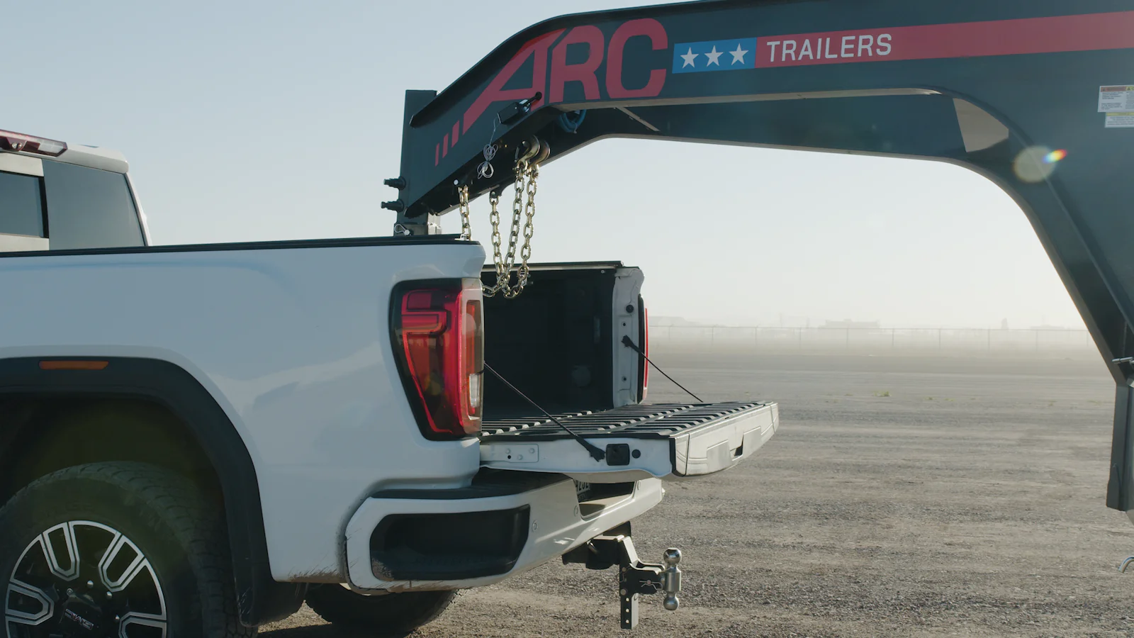 ARC Trailers gooseneck dump trailer connected to a pickup truck