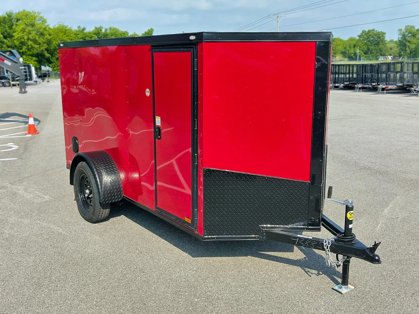 Red cargo trailer with black trim, three-quarter view